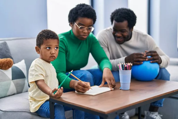 African american family drawing on notebook at home