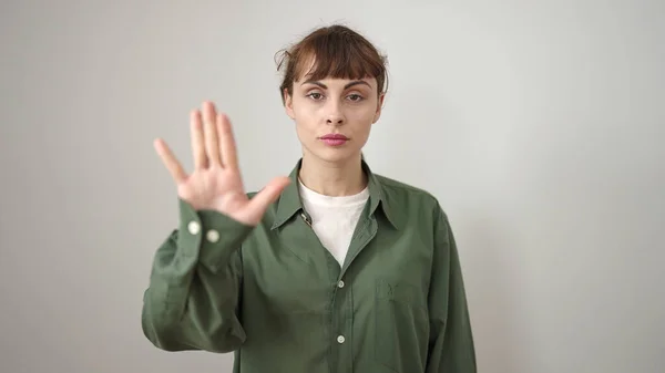 Young caucasian woman doing stop gesture with hand over isolated white background