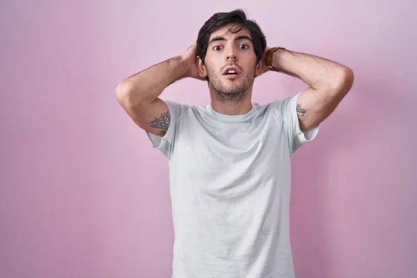 Young Hispanic Man Standing Pink Background Crazy Scared Hands Head — Stockfoto