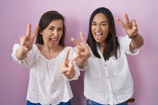 Hispanic Mother Daughter Together Smiling Tongue Out Showing Fingers Both — Fotografia de Stock