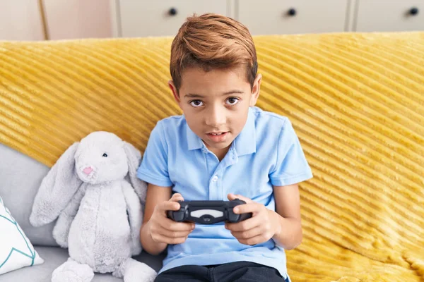 Adorable Hispanic Boy Playing Video Game Sitting Sofa Home — Zdjęcie stockowe