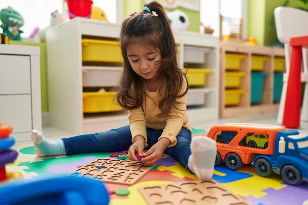 Adorable Hispanic Girl Playing Maths Puzzle Game Sitting Floor Kindergarten — 스톡 사진
