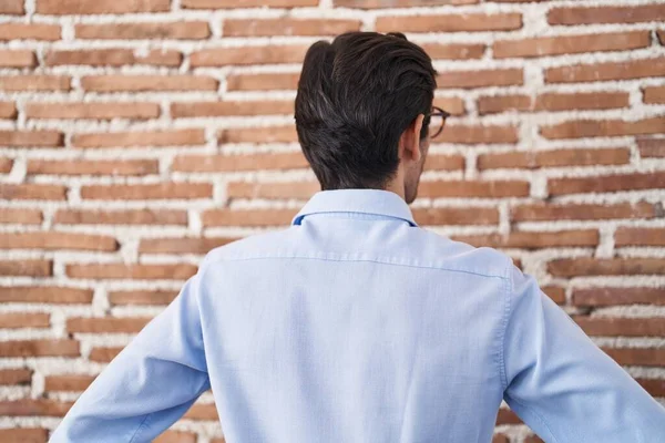 Young Hispanic Man Standing Brick Wall Background Standing Backwards Looking — Stockfoto