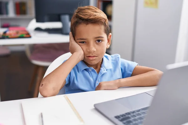 Adorable Hispanic Boy Student Using Computer Tired Expression Classroom — Fotografia de Stock