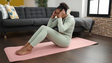 African american woman training abs exercise at home