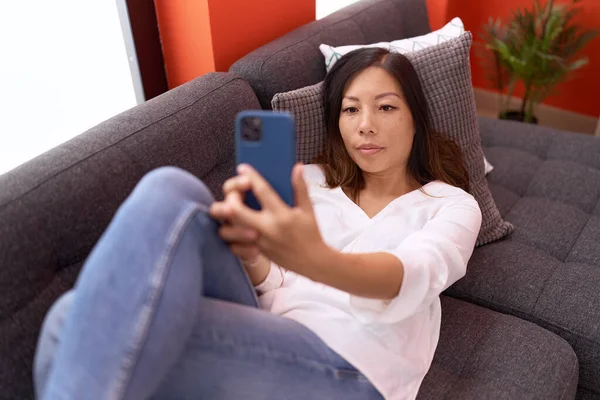 Young Asian Woman Make Selfie Smartphone Lying Sofa Home — Photo