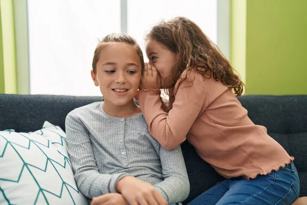 Two Kids Telling Secret Sitting Sofa Home — Stock fotografie