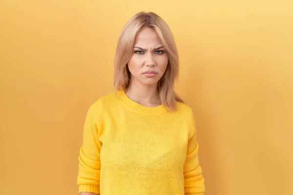 Young Caucasian Woman Wearing Yellow Sweater Skeptic Nervous Frowning Upset — 图库照片