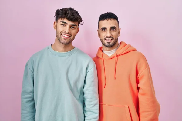 Young Hispanic Gay Couple Standing Pink Background Happy Cool Smile — Stockfoto
