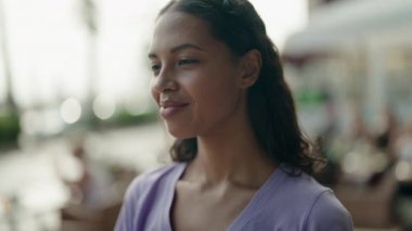 Young african american woman smiling confident looking to the side at street