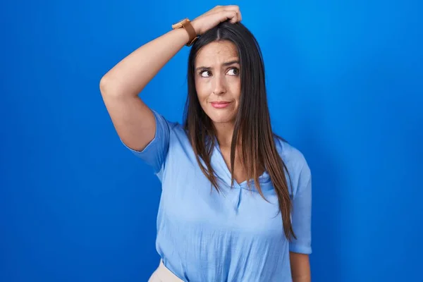 Young Brunette Woman Standing Blue Background Confuse Wondering Question Uncertain — Stok fotoğraf