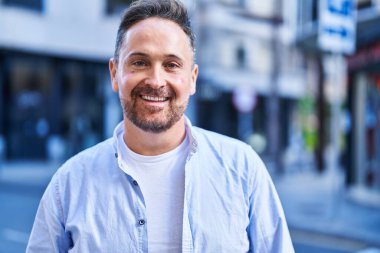 Young caucasian man smiling confident standing at street