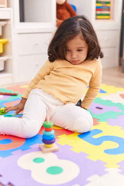 Adorable Hispanic Toddler Playing Hoops Toy Sitting Floor Kindergarten — Stok fotoğraf