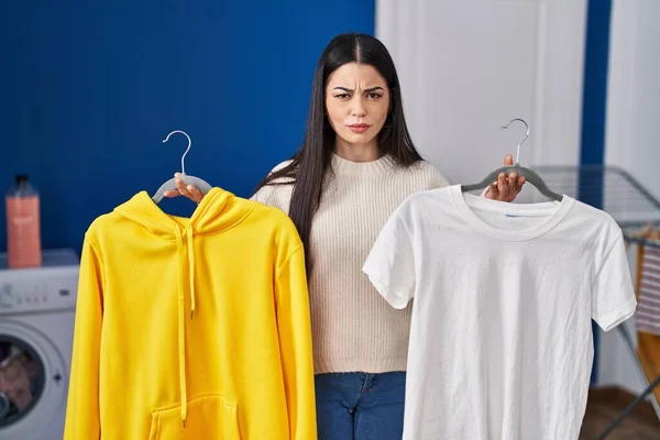 Young Woman Hanging Clothes Racks Skeptic Nervous Frowning Upset Because — Stock Photo, Image