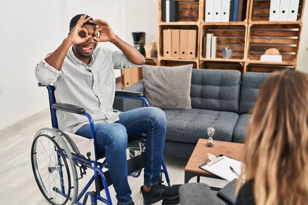 African American Man Doing Therapy Sitting Wheelchair Doing Gesture Binoculars — Stok fotoğraf