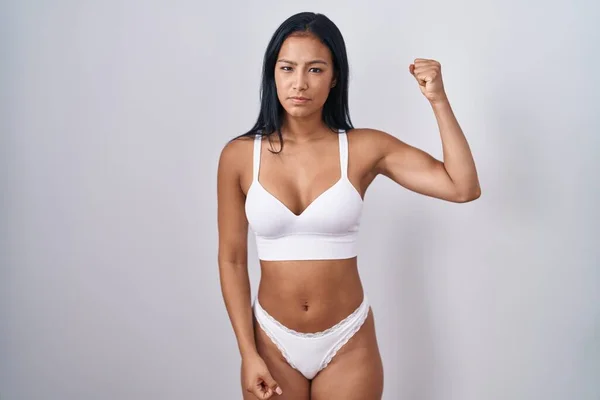 Hispanic Woman Wearing Lingerie Strong Person Showing Arm Muscle Confident — Zdjęcie stockowe