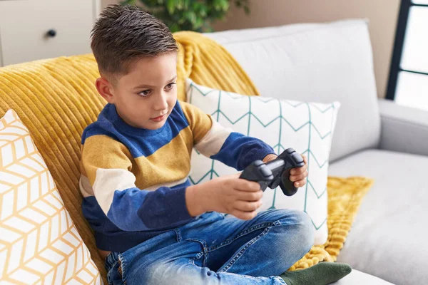 Adorable Hispanic Boy Playing Video Game Sitting Sofa Home —  Fotos de Stock