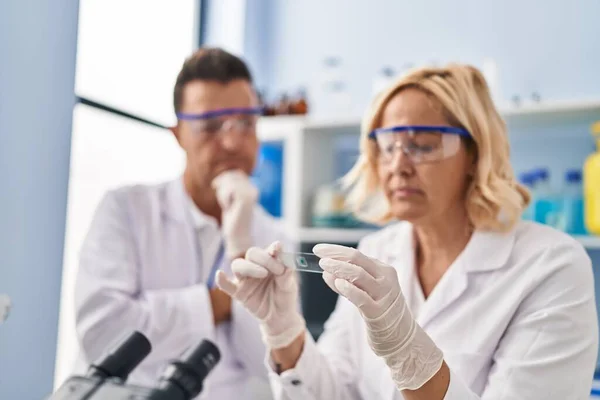 Middle Age Man Woman Scientist Partners Holding Sample Working Laboratory — Stock Photo, Image