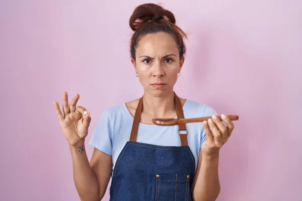 Brunette Woman Wearing Professional Cook Apron Holding Wooden Spoon Skeptic — Foto de Stock