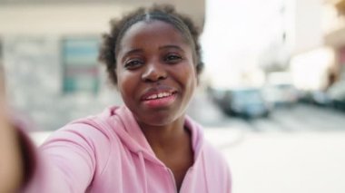 African american friends standing together having video call at street