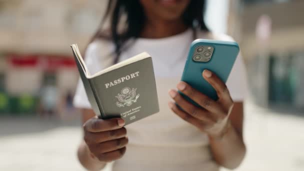 Young African American Woman Using Smartphone Holding United States Passport — ストック動画