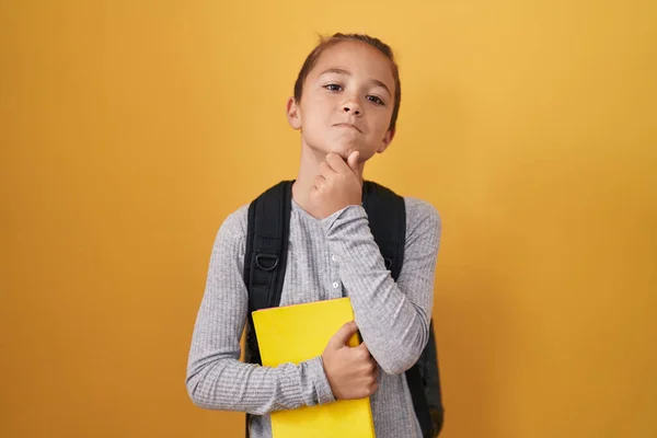 Little Caucasian Boy Wearing Student Backpack Holding Book Serious Face — Foto Stock