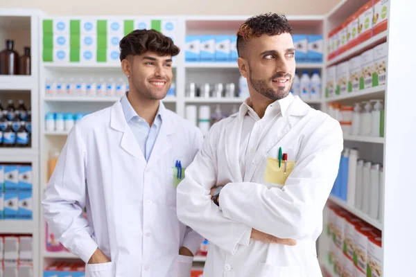 Two Hispanic Men Pharmacists Smiling Confident Standing Arms Crossed Gesture — Zdjęcie stockowe