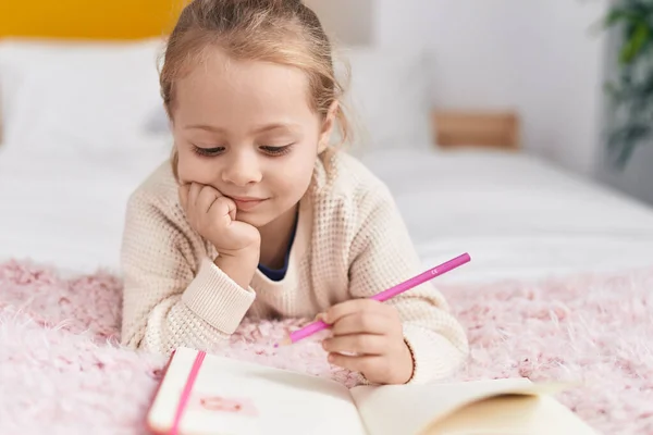 Adorable Blonde Girl Drawing Notebook Lying Bed Bedroom — Stok fotoğraf