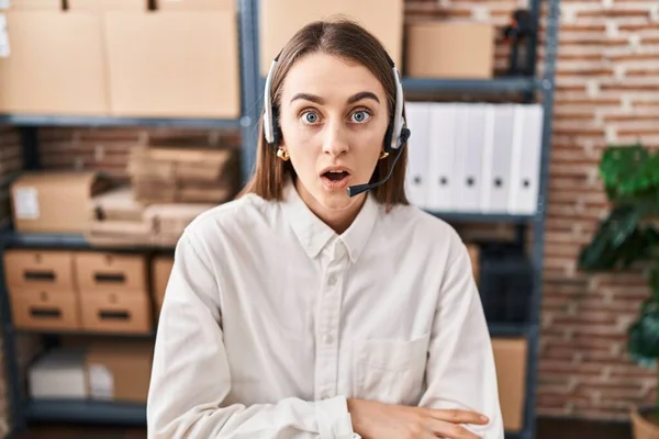 Young Caucasian Woman Working Small Business Ecommerce Wearing Headset Scared — Stock Fotó