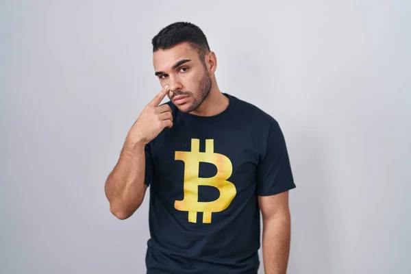Young Hispanic Man Wearing Bitcoin Shirt Pointing Eye Watching You —  Fotos de Stock