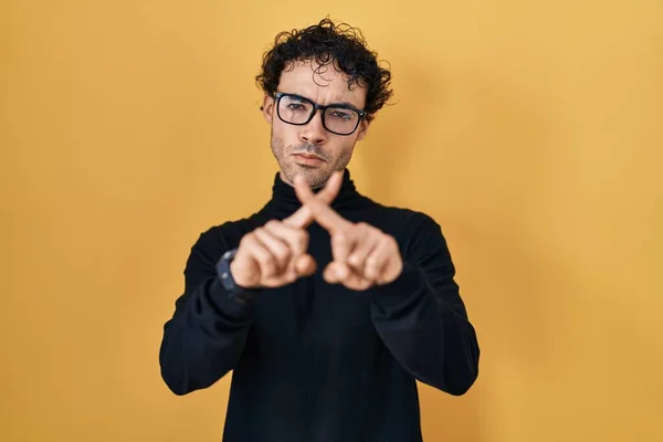 Hispanic Man Standing Yellow Background Rejection Expression Crossing Fingers Doing — ストック写真