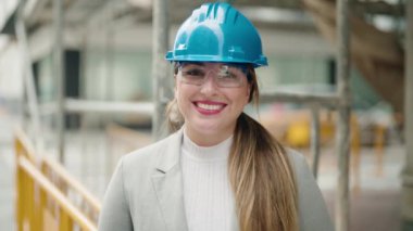 Young woman architect smiling confident standing at street