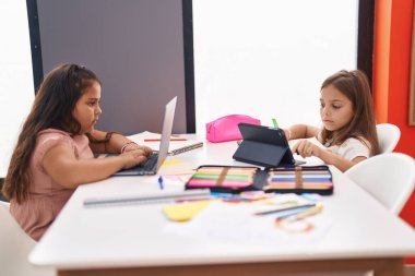 Two kids students sitting on table sleeping at classroom