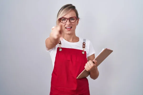 Young Blonde Woman Wearing Waiter Uniform Holding Clipboard Pointing Displeased — Stock fotografie