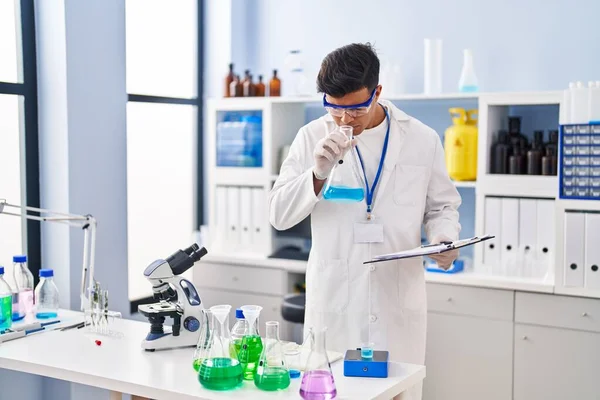 Young Hispanic Man Scientist Smelling Liquid Test Tube Laboratory — Photo