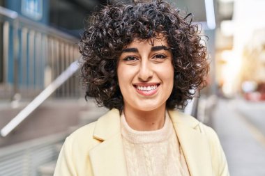 Young middle east woman excutive smiling confident standing at street