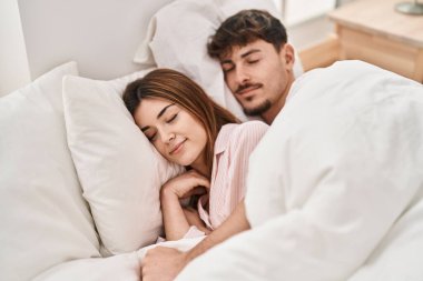 Mand and woman couple lying on bed sleeping at bedroom