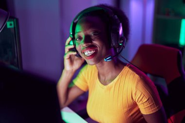 African american woman streamer using computer at gaming room