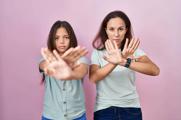 Young Mother Daughter Standing Pink Background Rejection Expression Crossing Arms —  Fotos de Stock