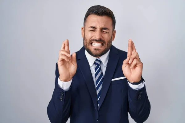 Handsome Hispanic Man Wearing Suit Tie Gesturing Finger Crossed Smiling — Foto de Stock