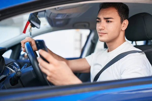 Young Hispanic Man Using Smartphone Sitting Car Street — Stockfoto
