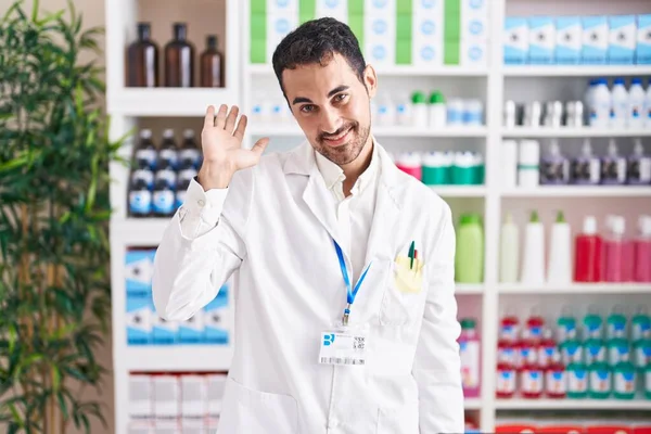 Handsome Hispanic Man Working Pharmacy Drugstore Waiving Saying Hello Happy — Foto de Stock