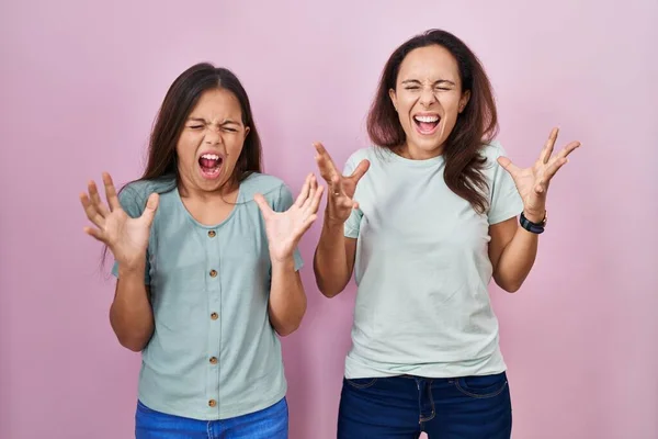 Young Mother Daughter Standing Pink Background Celebrating Mad Crazy Success —  Fotos de Stock