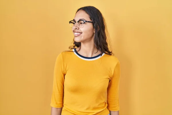 Young Brazilian Woman Wearing Glasses Yellow Background Looking Away Side — Stock Fotó