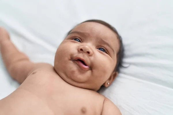 African American Baby Smiling Confident Lying Bed Bedroom — Zdjęcie stockowe