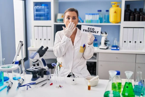 Middle Age Hispanic Woman Working Eco Friendly Laboratory Covering Mouth — Stockfoto
