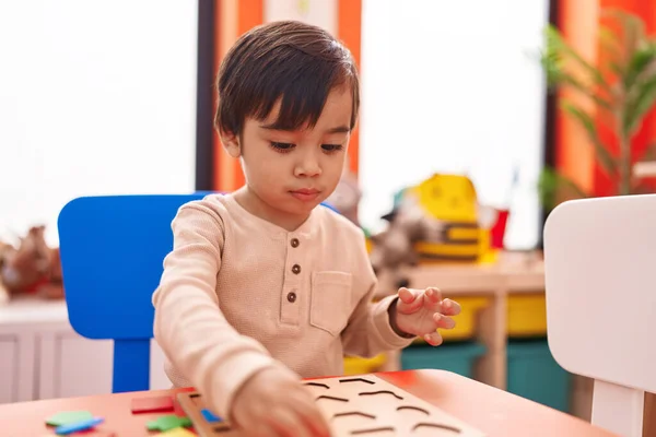 Adorable Hispanic Boy Playing Maths Puzzle Game Sitting Table Kindergarten — Fotografia de Stock