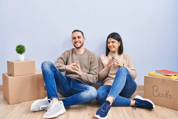 Young Couple Moving New Home Hands Together Fingers Crossed Smiling — Stock Photo, Image