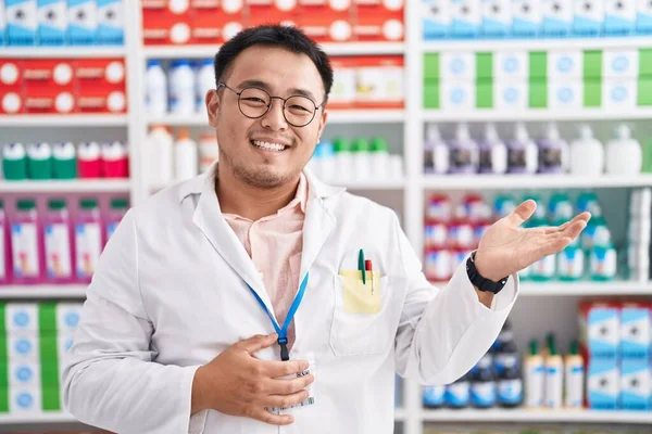 Joven Chino Trabajando Farmacia Sonriendo Alegre Presentando Señalando Con Palma —  Fotos de Stock