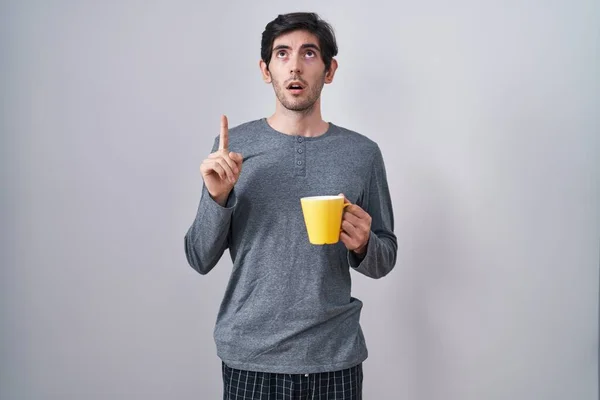 Young Hispanic Man Wearing Pajama Drinking Cup Coffee Amazed Surprised — Stock Fotó